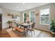 Cozy dining room with a rustic wooden table, bench seating, and views of the neighborhood at 2055 Eva Pearl Dr, Apex, NC 27502