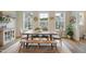 Inviting dining area featuring a wooden table, stylish chairs, and natural light with neighborhood views at 2055 Eva Pearl Dr, Apex, NC 27502