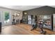 Exercise room with Peloton bikes, storage cabinets, and access to the outdoor patio at 2055 Eva Pearl Dr, Apex, NC 27502