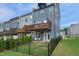 Rear exterior view of townhomes with decks and fenced backyards at 2055 Eva Pearl Dr, Apex, NC 27502