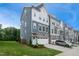 Beautifully designed townhome with blue and gray siding, stone accents, and a welcoming front lawn at 2055 Eva Pearl Dr, Apex, NC 27502