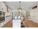 Bright kitchen features a center island with seating and modern appliances at 2055 Eva Pearl Dr, Apex, NC 27502