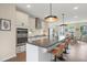 Spacious kitchen with an island and barstool seating, stainless steel appliances and an open floor plan at 2055 Eva Pearl Dr, Apex, NC 27502
