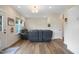 Cozy living room with wood floors, reclining couch, and access to an outdoor patio at 2055 Eva Pearl Dr, Apex, NC 27502