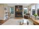 Bright living room features a fireplace with a modern design and natural light through the many windows at 2055 Eva Pearl Dr, Apex, NC 27502
