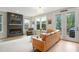Cozy living room with a modern fireplace, comfortable seating, and large windows offering serene outdoor views at 2055 Eva Pearl Dr, Apex, NC 27502