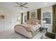 Main bedroom features a plush bed, neutral decor, and double windows at 2055 Eva Pearl Dr, Apex, NC 27502