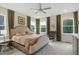 Bright main bedroom features neutral tones, a ceiling fan and several large windows at 2055 Eva Pearl Dr, Apex, NC 27502