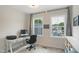 Bright office features carpeted floors, white desk, and a view of the neighborhood at 2055 Eva Pearl Dr, Apex, NC 27502