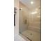 Modern glass enclosed walk-in shower with bench seating and tile surround at 2055 Eva Pearl Dr, Apex, NC 27502