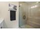 Glass enclosed shower with bench seating and tile surround at 2055 Eva Pearl Dr, Apex, NC 27502
