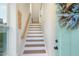 Bright and inviting staircase featuring wood treads, white risers, and a stylish handrail, perfect for a modern home at 2055 Eva Pearl Dr, Apex, NC 27502
