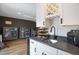 Wet bar with a stainless sink, gray countertops, wine rack, and display cabinets at 2055 Eva Pearl Dr, Apex, NC 27502