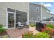 Well-maintained back patio with a grill and seating, perfect for outdoor entertaining at 212 Golf Vista Trl, Holly Springs, NC 27540