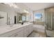 Stylish bathroom with double vanity, soaking tub, a separate shower, and natural light at 212 Golf Vista Trl, Holly Springs, NC 27540