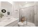 Clean bathroom features a gray-tiled shower and sleek white vanity at 212 Golf Vista Trl, Holly Springs, NC 27540