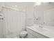 Bright bathroom featuring a single vanity, shower-tub combination, and neutral decor at 212 Golf Vista Trl, Holly Springs, NC 27540