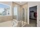 Bright bathroom boasts a soaking tub, tiled shower, and walk-in closet at 212 Golf Vista Trl, Holly Springs, NC 27540