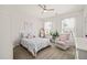 Bright bedroom with windows, a plush chair, and light-filled windows at 212 Golf Vista Trl, Holly Springs, NC 27540
