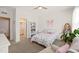 Bright bedroom with a cozy bed, a bookshelf, and light-filled windows at 212 Golf Vista Trl, Holly Springs, NC 27540