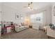 Bright room includes a couch, play kitchen, and toy storage at 212 Golf Vista Trl, Holly Springs, NC 27540