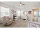 Bright bedroom with a crib, a comfortable chair, and neutral decor at 212 Golf Vista Trl, Holly Springs, NC 27540
