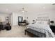 Large Primary bedroom features a workstation, queen bed, and a ceiling fan at 212 Golf Vista Trl, Holly Springs, NC 27540
