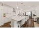 Spacious kitchen featuring a center island with seating, stainless appliances, and modern lighting at 212 Golf Vista Trl, Holly Springs, NC 27540