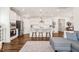 Bright and modern kitchen with a large island, pendant lighting, and open living space at 212 Golf Vista Trl, Holly Springs, NC 27540