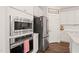 Close-up of a modern kitchen, showcasing stainless steel appliances and white cabinetry at 212 Golf Vista Trl, Holly Springs, NC 27540