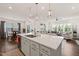 Bright, open-concept kitchen with a large island, stainless appliances, and seamless flow to living spaces at 212 Golf Vista Trl, Holly Springs, NC 27540