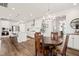 Open-concept kitchen with white cabinets, island seating, and stainless steel appliances at 212 Golf Vista Trl, Holly Springs, NC 27540