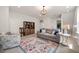 Bright living room showcasing a patterned rug, sofa, and bookcase at 212 Golf Vista Trl, Holly Springs, NC 27540