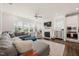 Inviting living room featuring a fireplace, large windows, plush seating, and an open layout at 212 Golf Vista Trl, Holly Springs, NC 27540