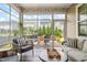 Inviting screened porch with comfortable seating and a view of the landscaped backyard at 212 Golf Vista Trl, Holly Springs, NC 27540