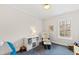Cozy bedroom with blue carpet, glider chair, and natural light from a window at 2147 Wake Dr, Raleigh, NC 27608