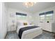 Comfortable bedroom featuring an accent rug, ceiling fan, and bedside tables at 2320 Marks Creek Rd, Knightdale, NC 27545