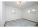 Bright bedroom with accent rug, ceiling fan and oversized windows at 2320 Marks Creek Rd, Knightdale, NC 27545