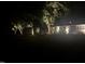 Outdoor lighting highlights a single-story home in the night, enhancing its appeal at 2320 Marks Creek Rd, Knightdale, NC 27545