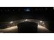 A stone firepit with integrated lighting creates a magical ambiance at night at 2320 Marks Creek Rd, Knightdale, NC 27545