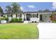 Charming one-story home with well-manicured lawn, white brick, black shutters, and covered front entrance at 2320 Marks Creek Rd, Knightdale, NC 27545