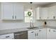 Close up on the kitchen counter, sink, and cabinets with stainless steel appliances at 2320 Marks Creek Rd, Knightdale, NC 27545