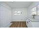 Eat-in kitchen with white cabinetry, granite counters, beadboard walls, and updated flooring at 2320 Marks Creek Rd, Knightdale, NC 27545