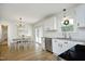 Open kitchenette area featuring sleek appliances, granite countertops, and backyard view at 2320 Marks Creek Rd, Knightdale, NC 27545