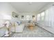 Bright living room featuring a sectional sofa, area rug, and abundant natural light at 2320 Marks Creek Rd, Knightdale, NC 27545