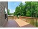 Relax on this wooden back deck overlooking the yard with mature trees and wood railing at 2575 Primrose Ln, Creedmoor, NC 27522
