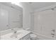 Bathroom with a tub/shower combo, toilet, and sink with neutral tiling throughout at 2575 Primrose Ln, Creedmoor, NC 27522