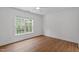 Minimal bedroom with a large window and ceiling fan with neutral colored flooring at 2575 Primrose Ln, Creedmoor, NC 27522