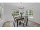 Cozy dining area with natural light, stylish chandelier, and dining table for four at 2575 Primrose Ln, Creedmoor, NC 27522