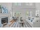Bright and airy living room with a fireplace, large windows, and hardwood flooring at 2575 Primrose Ln, Creedmoor, NC 27522